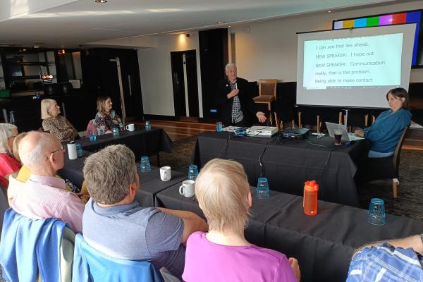 Meeting in progress with subtitled display 